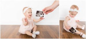 Little sister holds announcement of new sibling by Raindancer Studios Indianapolis Children Photographer Jill Howell