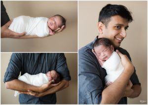 Father holding newborn baby boy in white swaddle by Raindancer Studios Indianapolis Newborn Photographer Jill Howell