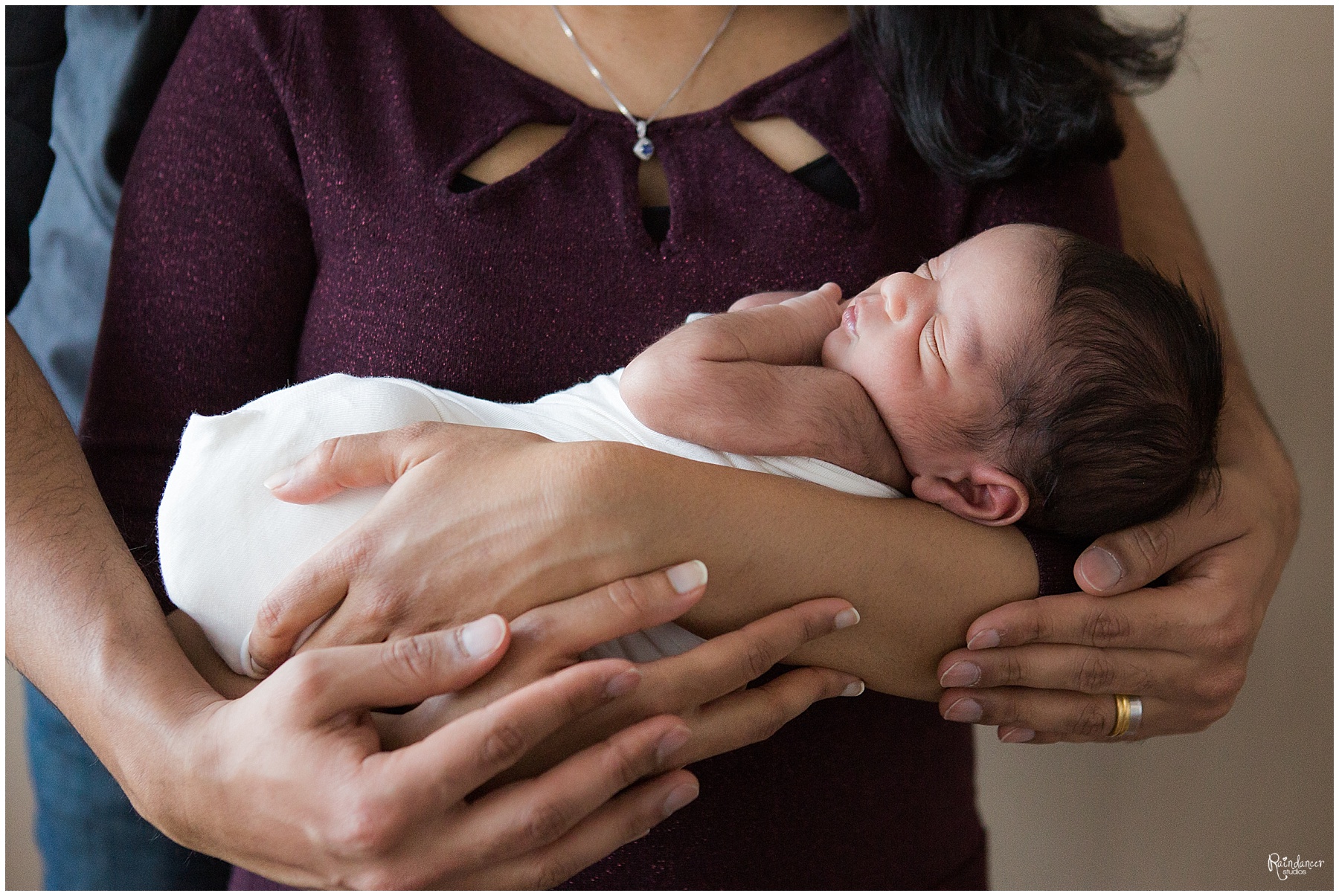 Parents holding newborn baby boy by Raindancer Studios Indianapolis Newborn Photographer Jill Howell