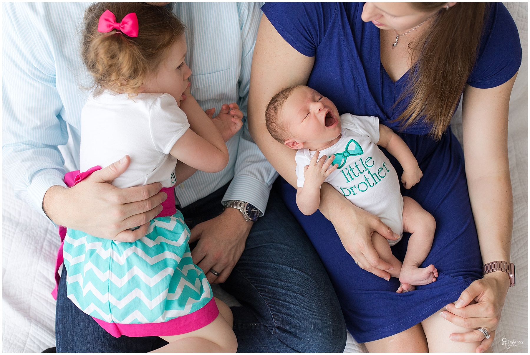 Parents cuddling daughter and newborn baby boy by Raindancer Studios Indianapolis Newborn Photographer Jill Howell