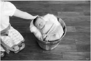 Big sister touching newborn baby brothers head by Raindancer Studios Indianapolis Newborn Photographer Jill Howell