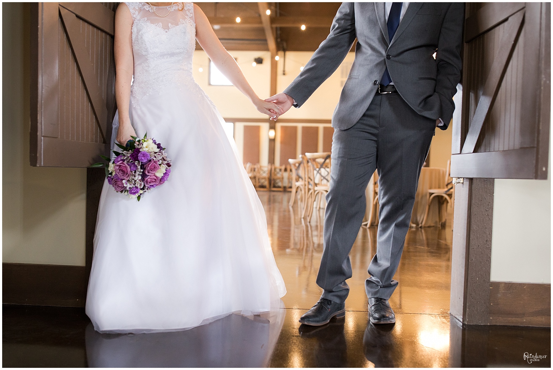 Bride and groom holding hands in a doorway by Raindancer Studios Indianapolis Wedding Photographer Jill Howell