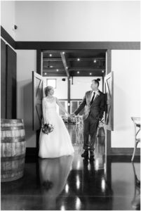 Bride and groom holding hands in a doorway by Raindancer Studios Indianapolis Wedding Photographer Jill Howell