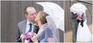 Bride and groom kissing under parasol umbrella with groom by Raindancer Studios Indianapolis Wedding Photographer Jill Howell