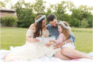 Parents reading to their daughters in the field, Indianapolis Maternity Photography