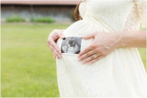 Mother holding baby girls ultrasound on her growing belly, Indianapolis Maternity Photography