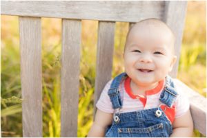 Baby girl smiling on outdoor bench, Indianapolis Family Photography, Raindancer Studios