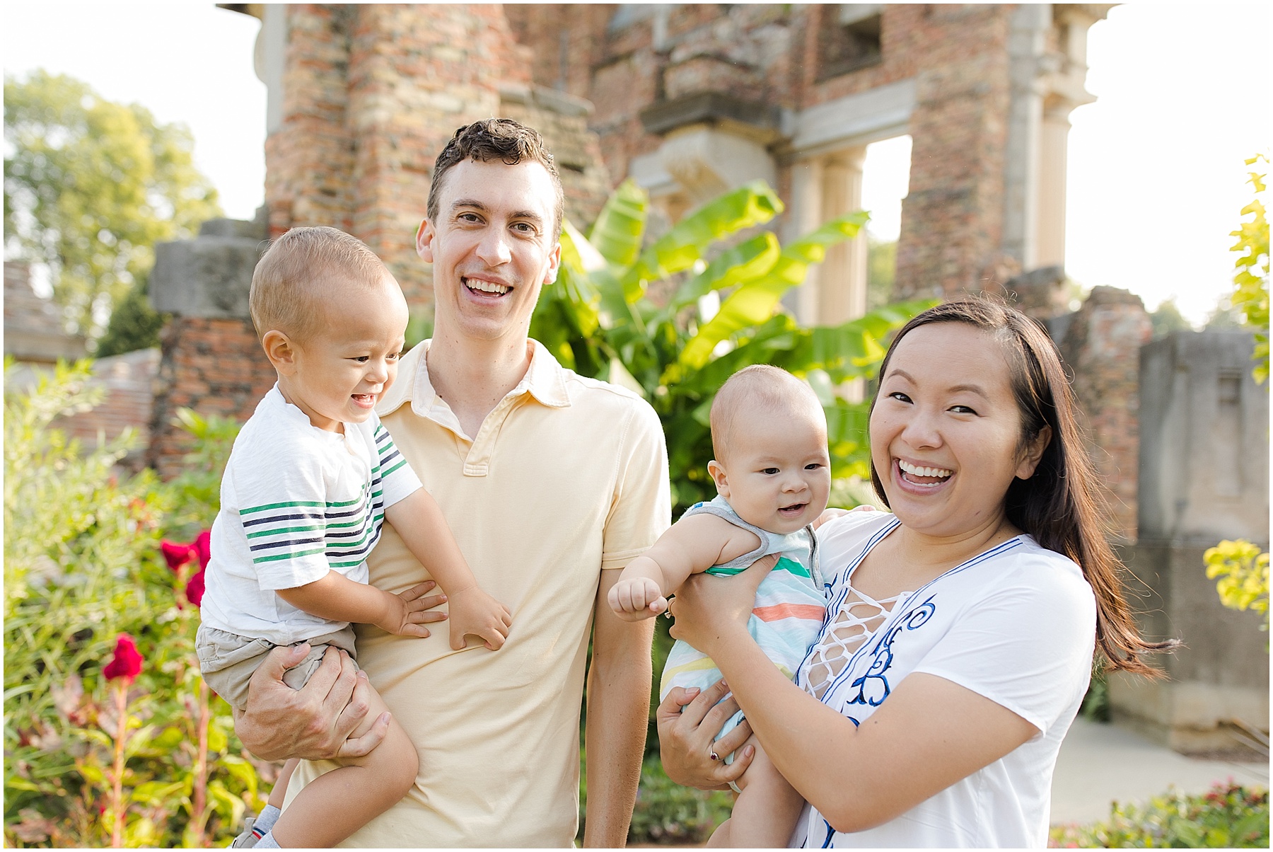 Parents holding their baby girl and toddler boy.  Indianapolis Family Photography, Raindancer Studios