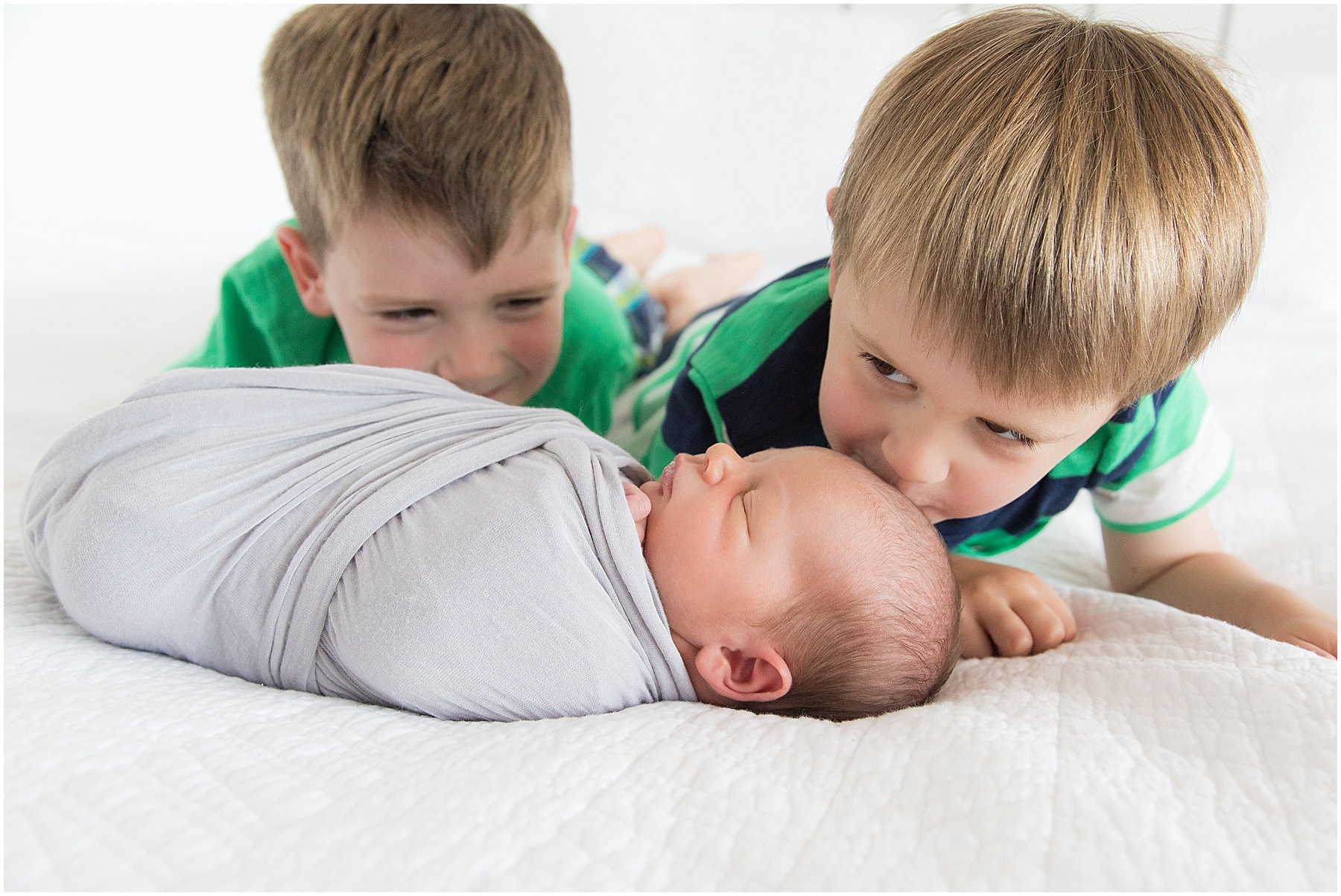 Big brothers kissing baby brother on forehead, Indianapolis Children Photography, Raindancer Studios