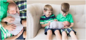 Big brothers giggling while holding newborn baby brother, Indianapolis Children Photography, Raindancer Studios