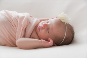 Newborn girl swaddled in light pink blanket. Indianapolis Baby Photographer